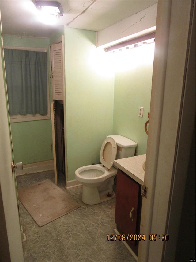 bathroom featuring toilet and vanity