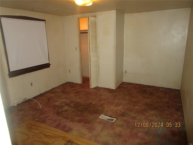 unfurnished bedroom featuring carpet floors and a closet