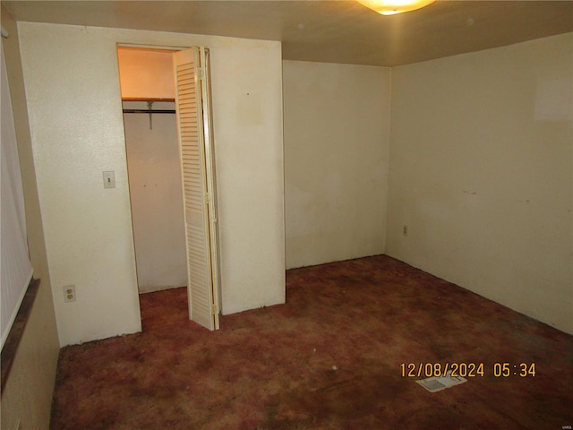 unfurnished bedroom featuring a closet and carpet floors