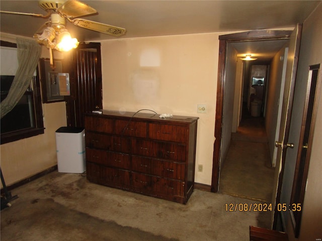 bedroom with carpet, electric panel, baseboards, and a ceiling fan