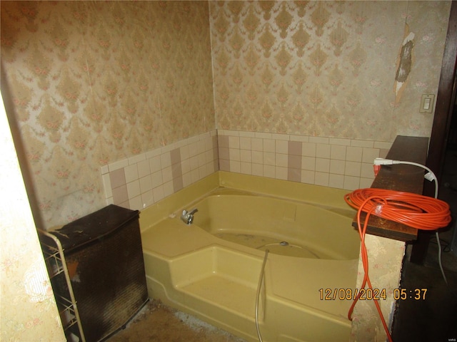 full bathroom with wallpapered walls and a garden tub