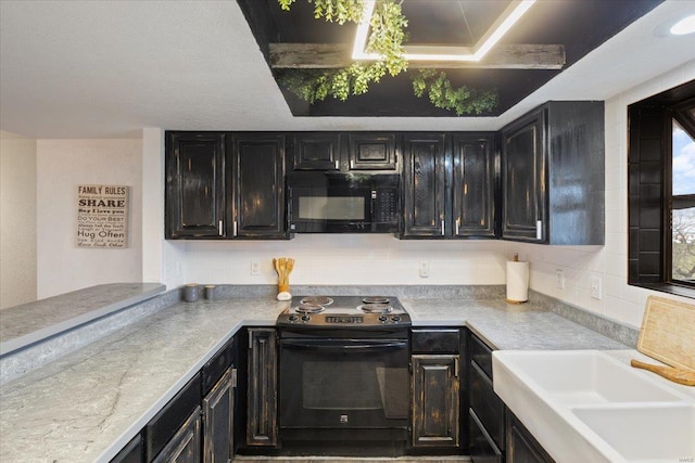 kitchen with black appliances, light countertops, dark cabinetry, and a sink