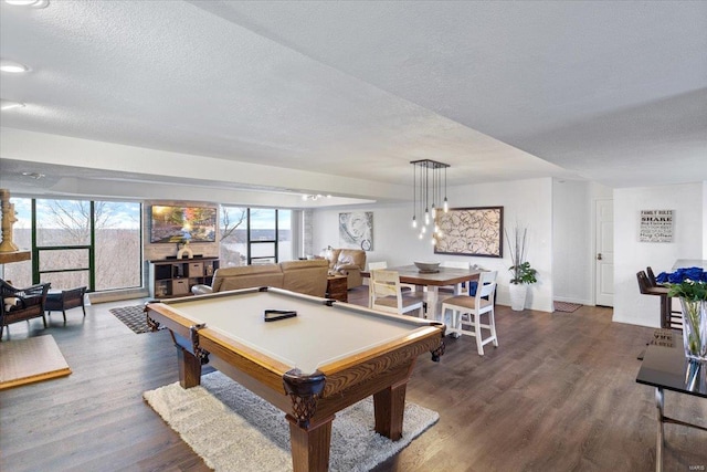 game room featuring dark wood finished floors, a textured ceiling, and billiards table