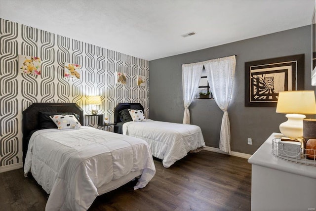 bedroom with baseboards and dark wood-style floors