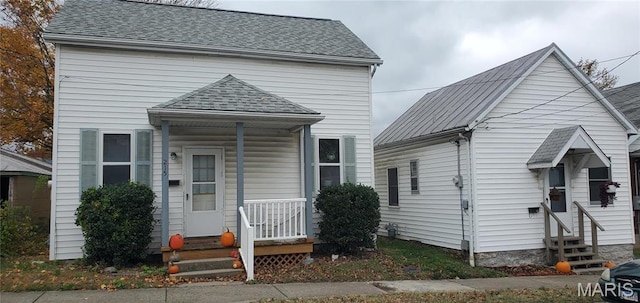 view of front of home with entry steps and roof with shingles