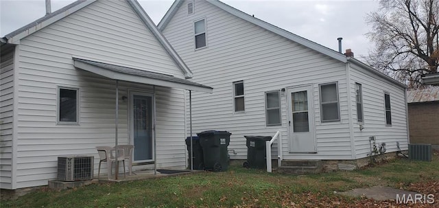 rear view of property featuring cooling unit