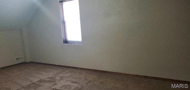 unfurnished room featuring carpet and baseboards