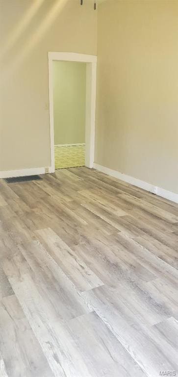 bonus room featuring wood finished floors, lofted ceiling, and baseboards