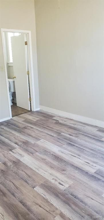 unfurnished room with wood finished floors and baseboards