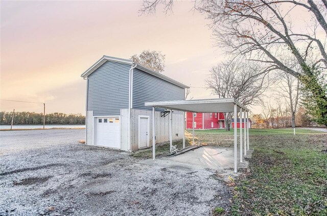 1100 W Main St, Grafton, IL 62037 - view of home's exterior with gravel driveway, a garage, and an outdoor structure