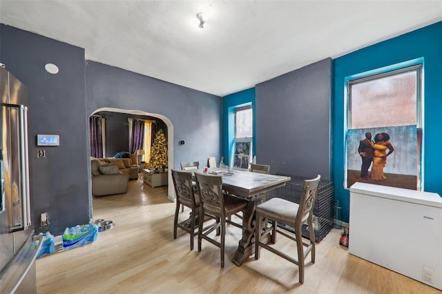 3833 Marine Ave, Saint Louis, MO 63118 - dining area with arched walkways and wood finished floors