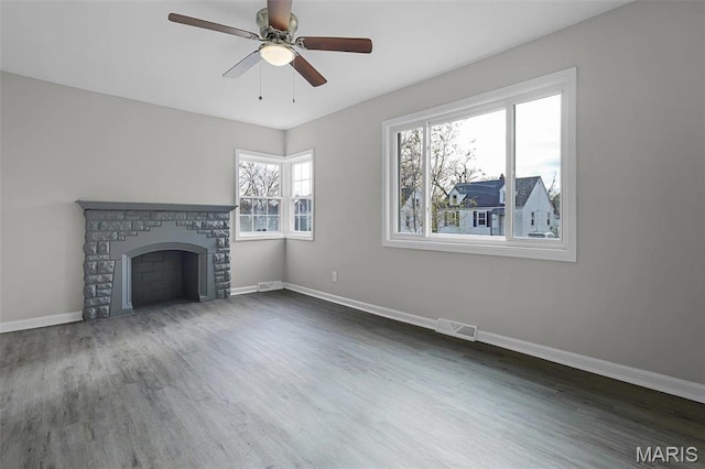 1021 Lakeview Ave, Saint Louis, MO 63138 - unfurnished living room featuring baseboards, wood finished floors, a ceiling fan, and a fireplace