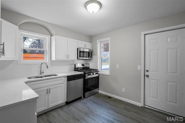 1021 Lakeview Ave, Saint Louis, MO 63138 - kitchen featuring stainless steel appliances, a sink, decorative backsplash, and white cabinets