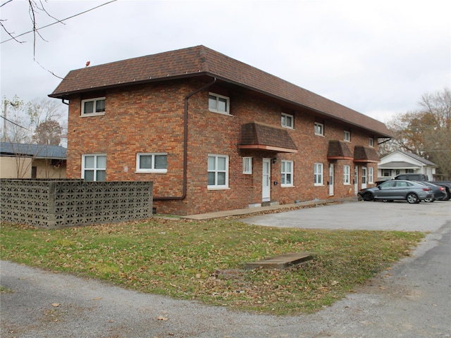 419 W Main St, Duquoin, IL 62832 - view of property exterior featuring roof with shingles, brick siding, and mansard roof