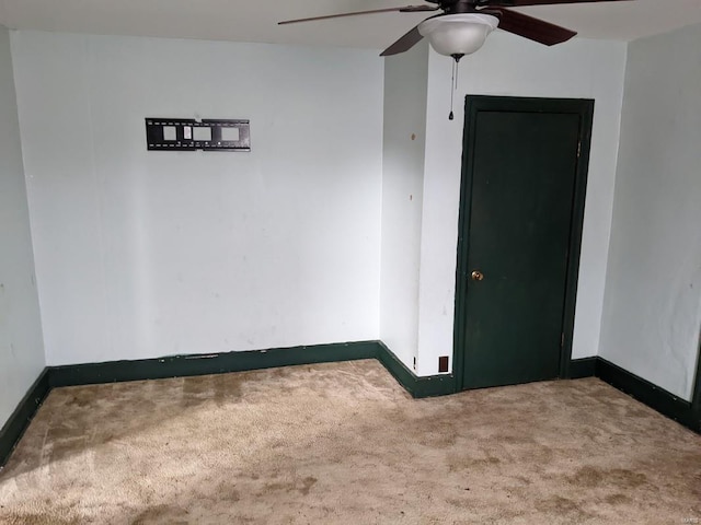 unfurnished room featuring carpet flooring, a ceiling fan, and baseboards