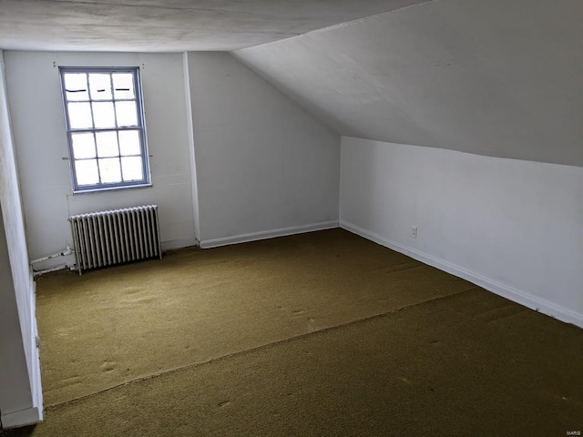 bonus room with radiator heating unit, carpet floors, lofted ceiling, and baseboards