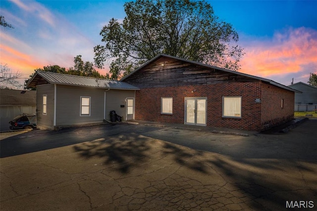 501 Lewis St, Park Hills, MO 63601 - back of property at dusk with brick siding and metal roof