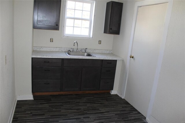 842 Kinzer St, Poplar Bluff, MO 63901 - kitchen featuring a sink, dark wood finished floors, light countertops, and baseboards