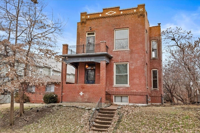 4361 Laclede Ave, Saint Louis, MO 63108 - view of front of house featuring a balcony, brick siding, and stairs