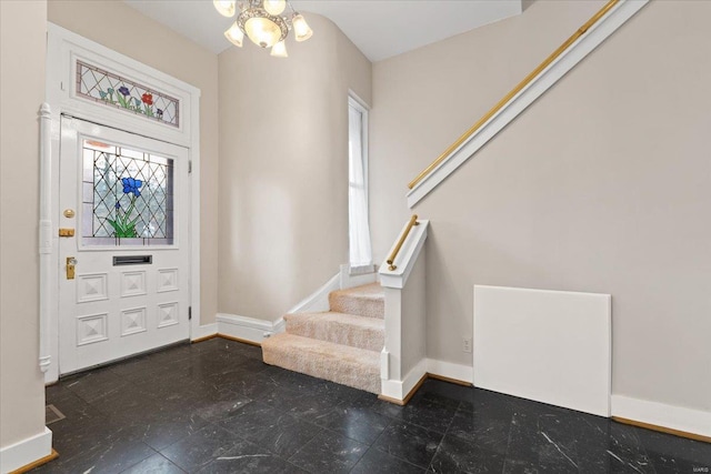 4361 Laclede Ave, Saint Louis, MO 63108 - foyer entrance with stairway, baseboards, and a chandelier