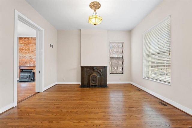 4361 Laclede Ave, Saint Louis, MO 63108 - unfurnished living room with wood finished floors and baseboards