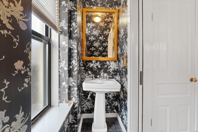 4361 Laclede Ave, Saint Louis, MO 63108 - bathroom featuring wallpapered walls, baseboards, and a sink