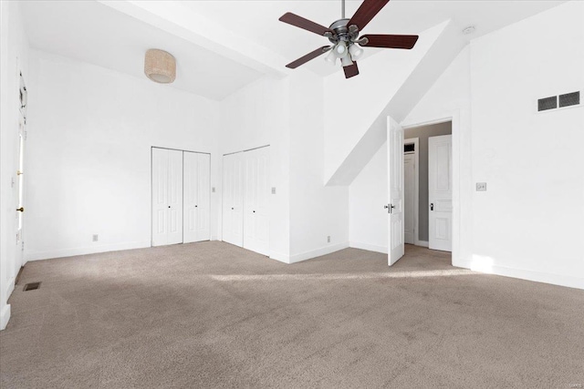 4361 Laclede Ave, Saint Louis, MO 63108 - unfurnished bedroom featuring high vaulted ceiling, carpet flooring, two closets, baseboards, and ceiling fan