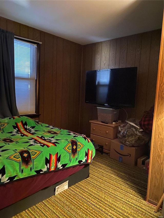 bedroom with wood walls and carpet flooring