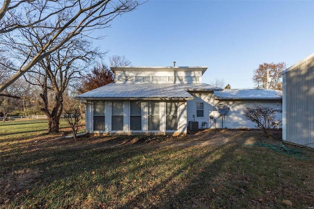 1728 Hitching Post Ln, Farmington, MO 63640 - rear view of house with a sunroom, central AC, metal roof, and a yard