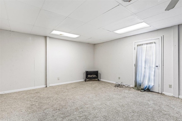 1728 Hitching Post Ln, Farmington, MO 63640 - basement with carpet, a wood stove, a drop ceiling, and baseboards