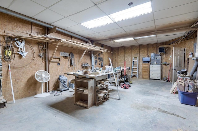 1728 Hitching Post Ln, Farmington, MO 63640 - below grade area featuring a workshop area, a paneled ceiling, and wood walls