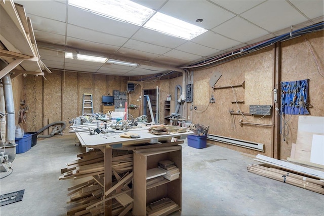 1728 Hitching Post Ln, Farmington, MO 63640 - below grade area featuring baseboard heating, a workshop area, and a drop ceiling