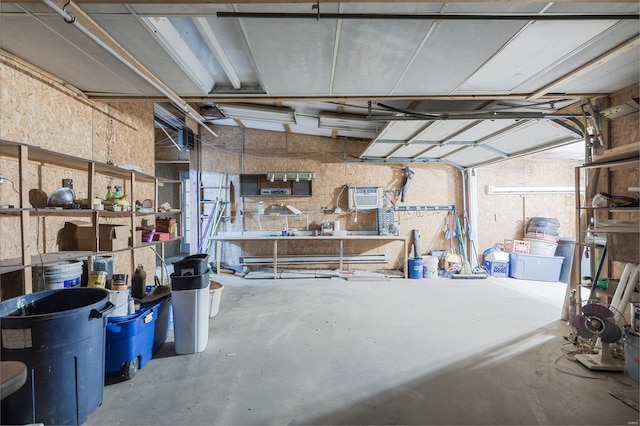 1728 Hitching Post Ln, Farmington, MO 63640 - garage with a wall unit AC and a workshop area
