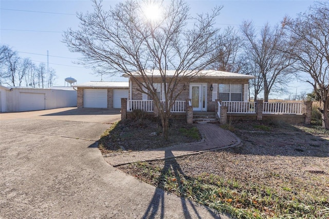 1728 Hitching Post Ln, Farmington, MO 63640 - single story home with a porch, a detached garage, brick siding, and an outbuilding