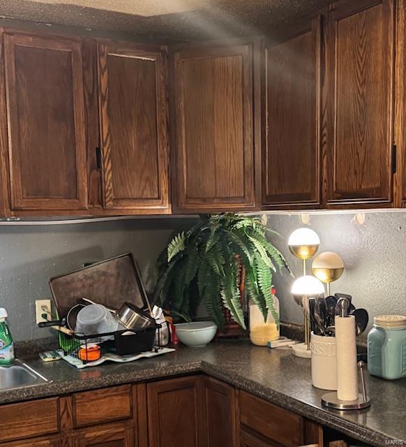 kitchen with dark countertops and a textured ceiling