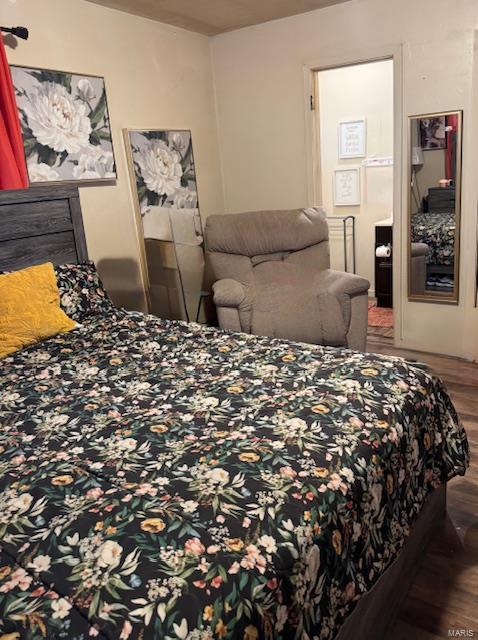 bedroom with wood finished floors
