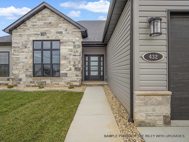 428 Hayden Dr, Waterloo, IL 62298 - doorway to property with stone siding, roof with shingles, and a yard