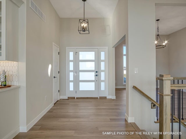 428 Hayden Dr, Waterloo, IL 62298 - entryway featuring a chandelier, wood finished floors, baseboards, and a towering ceiling