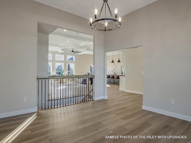428 Hayden Dr, Waterloo, IL 62298 - unfurnished dining area with a chandelier, wood finished floors, a ceiling fan, baseboards, and recessed lighting