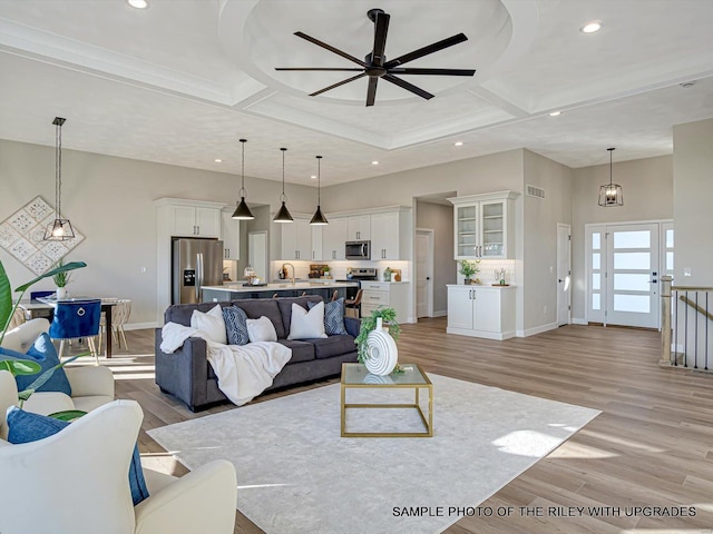 428 Hayden Dr, Waterloo, IL 62298 - living room with coffered ceiling, a towering ceiling, ceiling fan, light wood-type flooring, and baseboards