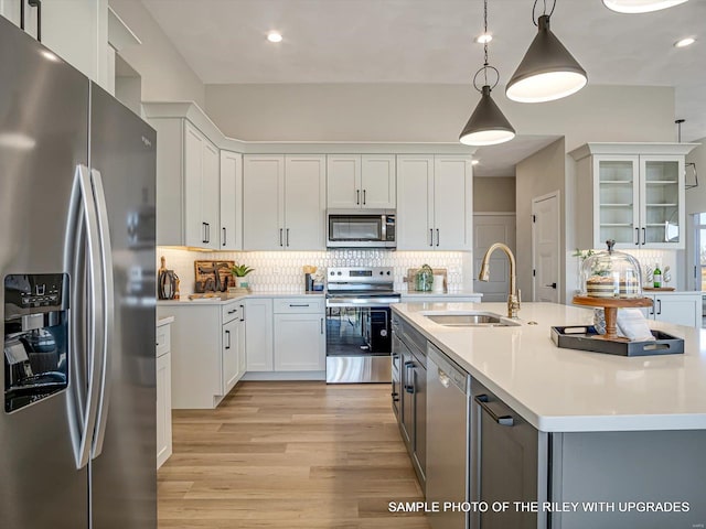 428 Hayden Dr, Waterloo, IL 62298 - kitchen with stainless steel appliances, a sink, backsplash, light countertops, and white cabinetry