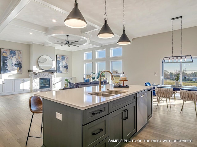 428 Hayden Dr, Waterloo, IL 62298 - kitchen with a sink, dishwasher, a ceiling fan, light wood-type flooring, and light countertops