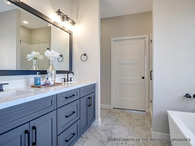 428 Hayden Dr, Waterloo, IL 62298 - bathroom featuring marble look tile flooring, baseboards, a tub, and double vanity