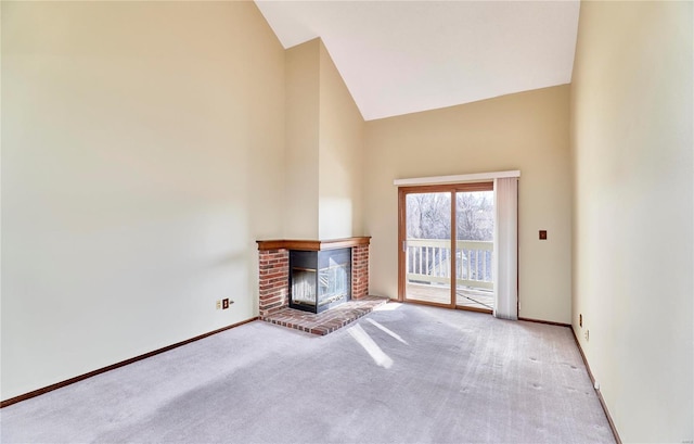 unfurnished living room with high vaulted ceiling, a fireplace, carpet flooring, and baseboards