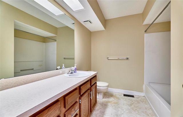 bathroom featuring toilet, vanity, and baseboards