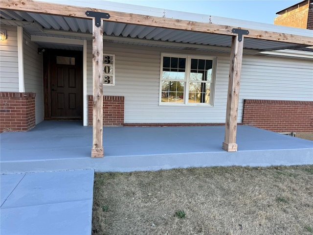 303 N State St, Desloge, MO 63601 - view of exterior entry with covered porch and brick siding