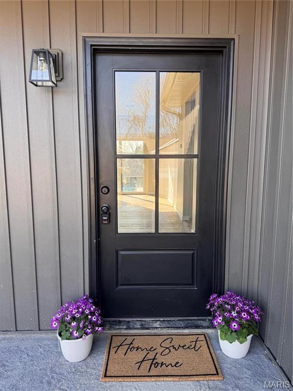 property entrance featuring board and batten siding