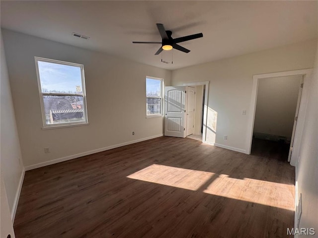 unfurnished bedroom with wood finished floors, baseboards, and ceiling fan