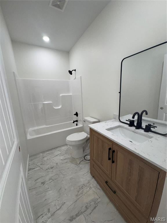 full bathroom with marble finish floors, tub / shower combination, vanity, and toilet