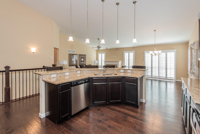 kitchen featuring stainless steel dishwasher, a sink, open floor plan, dark wood-style flooring, and a fireplace